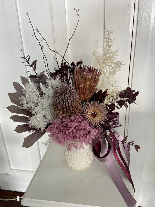 Bouquet of dried flowers with a ribbon against a white background